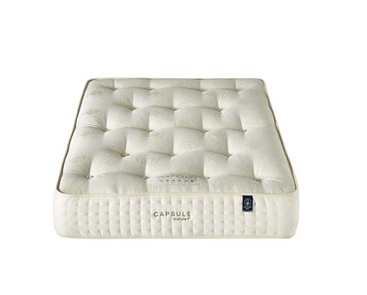 A white tufted mattress shown from a top-down angle on a plain white background. The brand name 'CAPSULE' is visible on the side of the mattress.