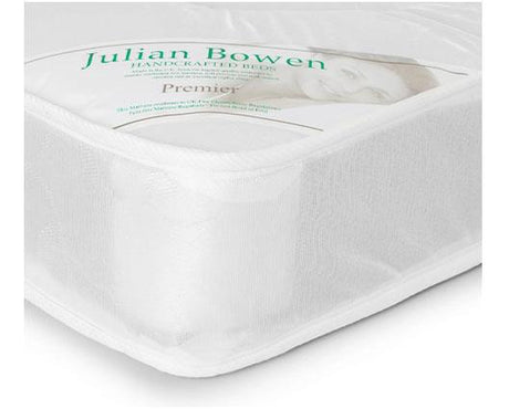 A white upholstered bed frame or mattress shown at an angle on a white background, with a clear window revealing the brand label 'Julian Bowen Premier'.
