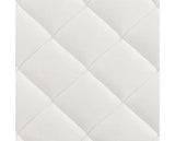 Close-up of a white quilted mattress fabric surface with stitched diamond panels.