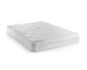 A white quilted mattress topper or mattress with a diamond-patterned top surface, shown at an angle on a plain white background.