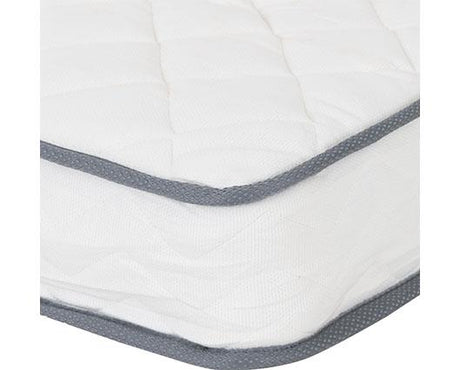 A close-up of a white quilted mattress topper or mattress corner with gray piping trim along the edges.
