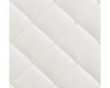 Close-up of a white mattress quilted fabric surface with stitched diamond panels.