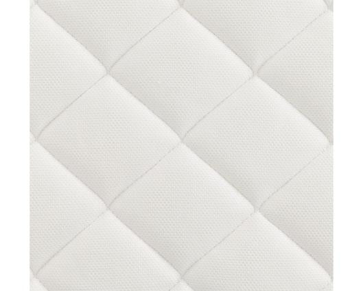 A close-up of a white quilted fabric surface with stitched diamond panels.