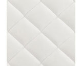 A close-up of a white quilted fabric surface with stitched diamond panels.