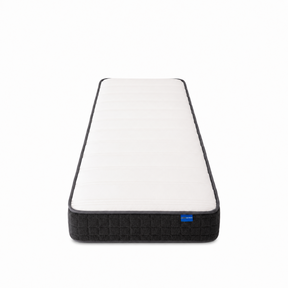 A single mattress shown from a top-down perspective on a clean white background. The mattress features a white quilted top surface with a dark gray or black textured base and a small blue brand tag on the right side.