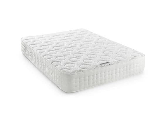A white quilted king size mattress shown at an angle on a clean white background.
