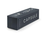 A dark charcoal gray rectangular product box with white text reading 'CAPSULE' and small white icons printed on top, shown on a clean white background.